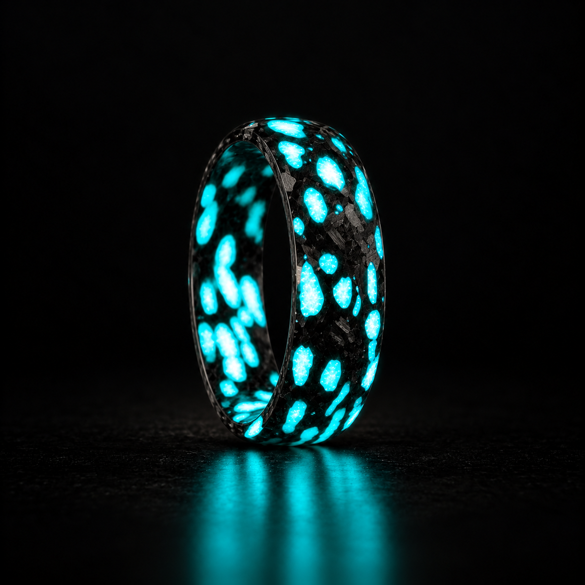 Alien Carbon Fiber Ring - Blue in a uniform upright three-quarter view on a dark background