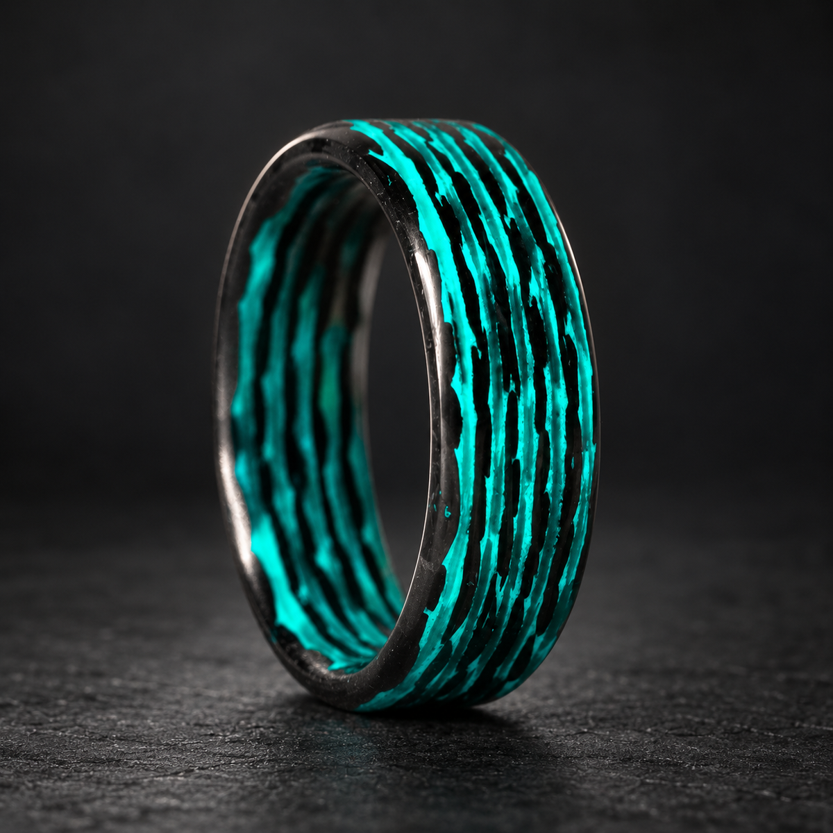 Aqua Matrix Lume carbon fiber ring on a dark studio background