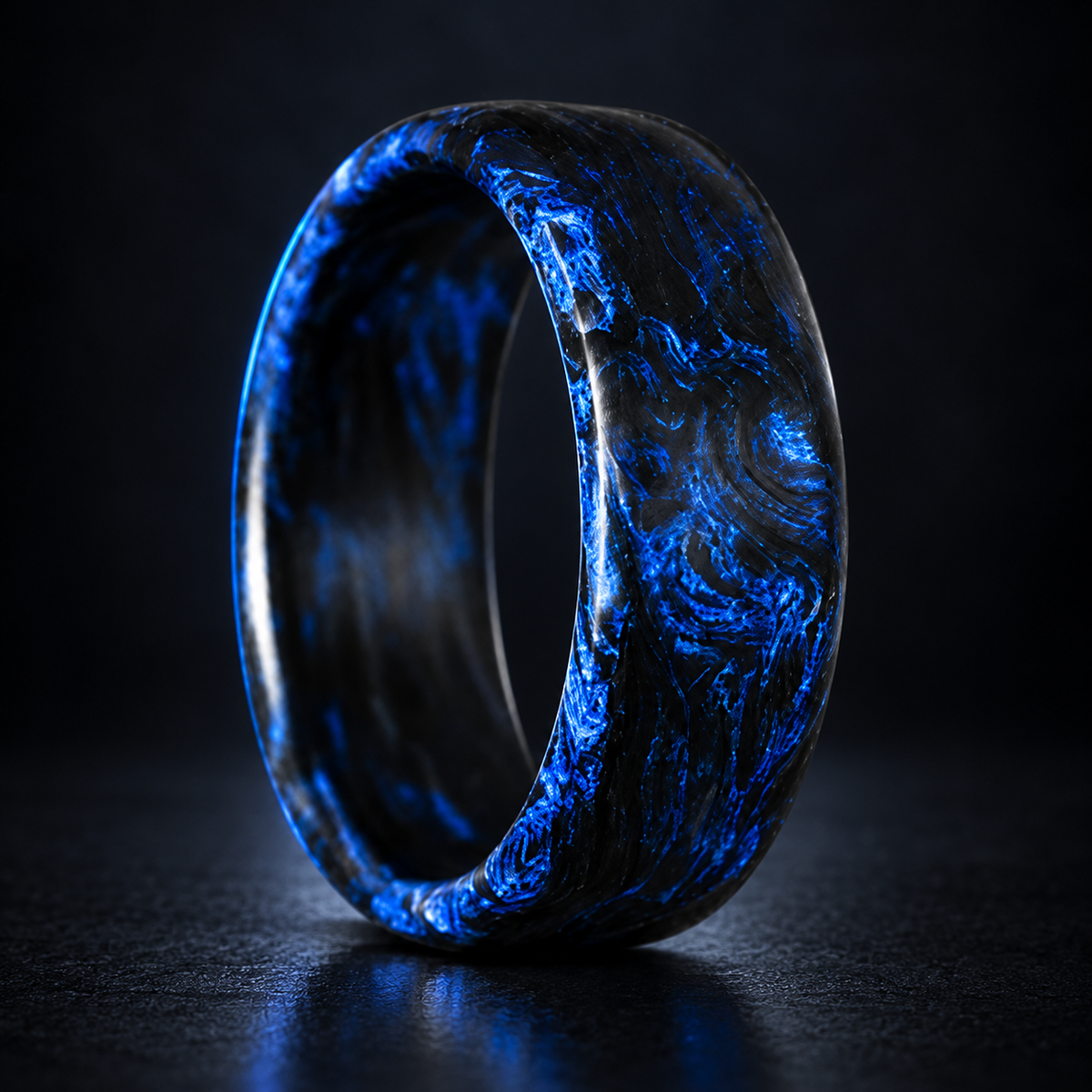 Carbon Storm Navy forged carbon fiber ring on a dark studio background